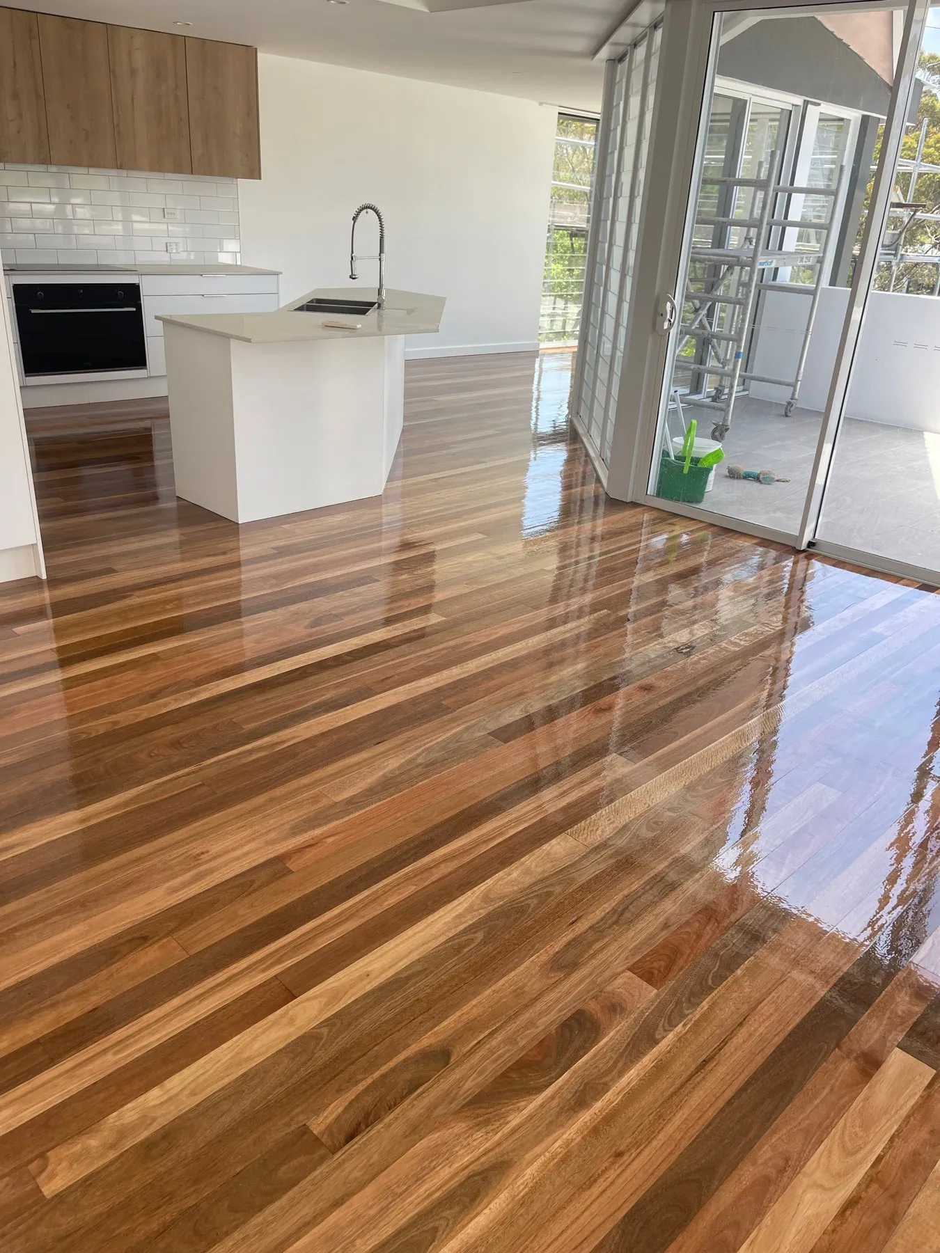 Glossy finished timber floor in a bright kitchen