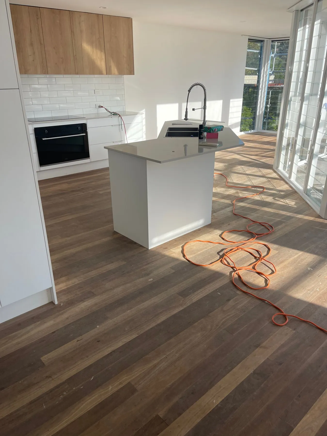 Sanded and polished timber floor through an open plan kitchen and living area