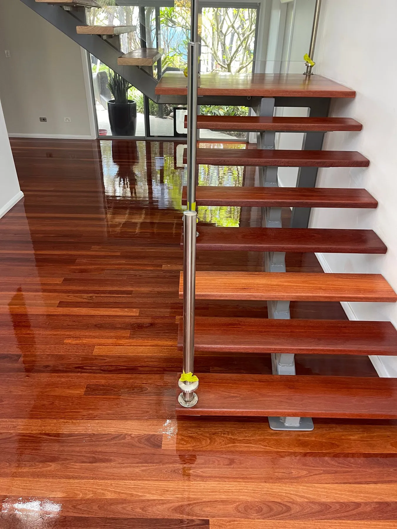 Polished timber stair treads and floor with a glossy finish